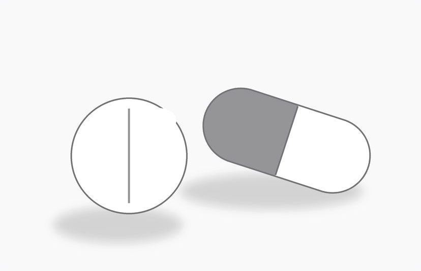 Two oral hair-loss pills — a capsule and a tablet